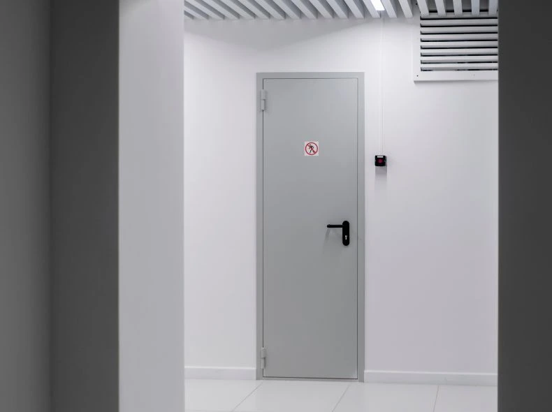 KOR India professional fire door installation team fitting a fire rated door with certified hardware on a construction site