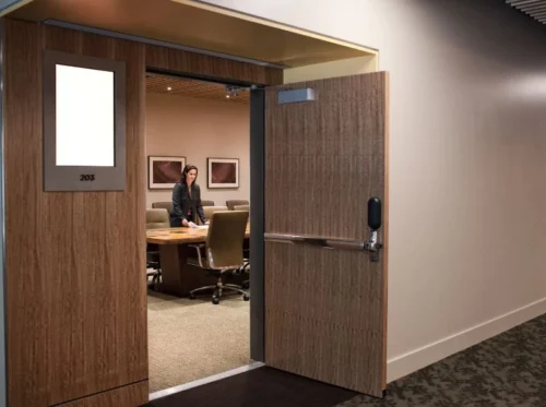 Wooden fire-rated door with elegant finish in a modern office interior